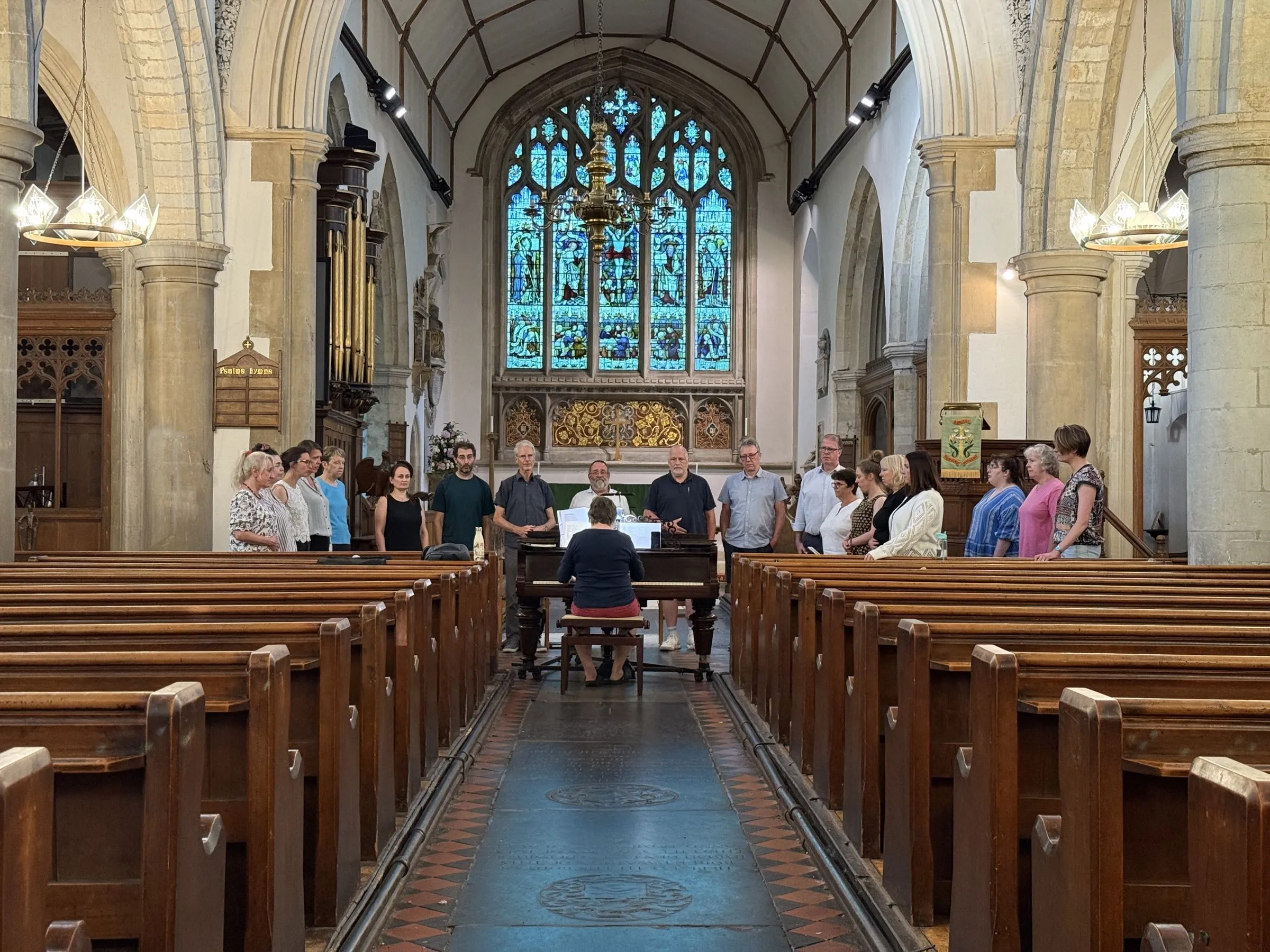 Looking down the nave aisle of All Saints' Church, Writtle, to the choir rehearsing beneath the east window